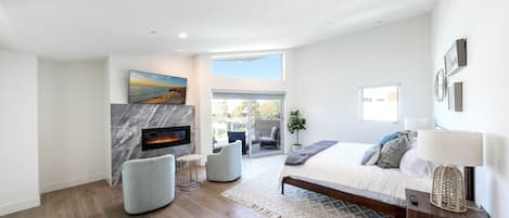 Third level master bedroom with smart TV, fireplace, balcony