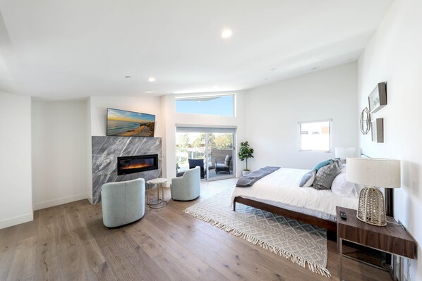 Third level master bedroom with smart TV, fireplace, balcony