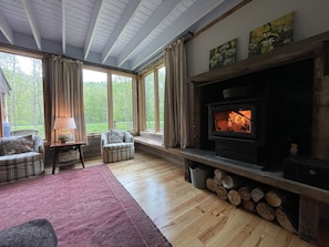 Sitting room with woodstove, 2 sofas, ottoman and 2 chairs and lots of room!