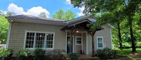 Discover a cozy, charming single-story home with a fireplace-adorned living room, spacious dining area, functional kitchen, and inviting porch, offering a simple yet elegant living space.