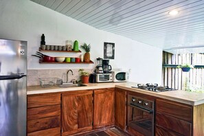 Modern wooden outside style kitchen viewing the pool and garden
