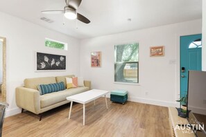 Living room with smart tv and open to the kitchen