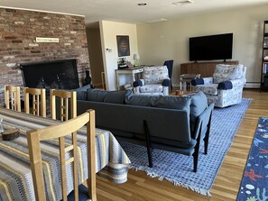 Open concept living/dining room, with office workspace in corner