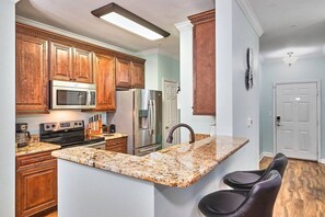 Discover a cozy kitchen nook with a breakfast bar and two swivel high chairs.