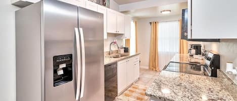 The kitchen features a spacious cabinet that allows for excellent food storage