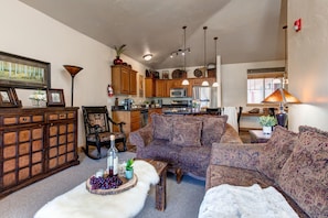 Living Room with plush sofa & loveseat, gas fireplace, 50" TV, and private deck access