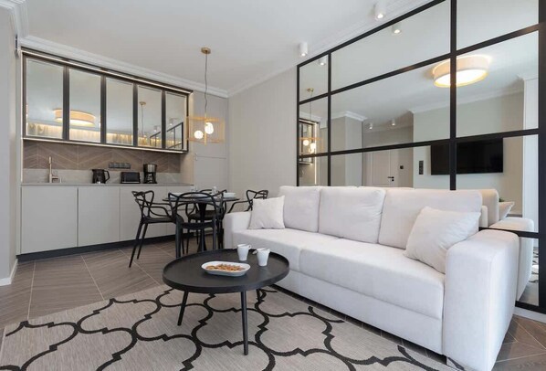 Relax in the stylish living room with a comfortable sofa and modern decor.