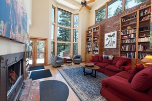 Main Living Space with mountain views, wood burning fireplace, TV and deck access