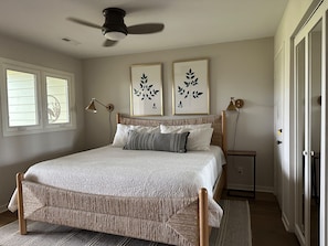 The master suite is on the first floor. This amazing space has a king bed, ceiling fan and separate sitting room.