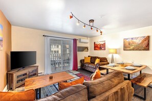 Resort Plaza 5024 living room with 2 comfortable suede couches and flat screen TV.