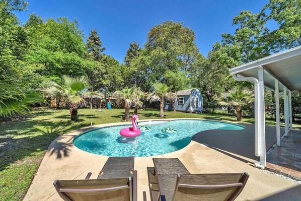 Catch all the rays in this beautiful private backyard, large pool, and play set!