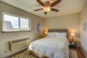Bedroom with 2 nightstands, air conditioner, and overhead fan