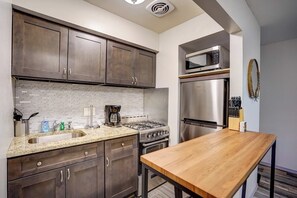 Kitchen with block table for extra counter space.