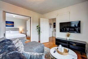 View from living room toward bedroom and door to dining room.  Doors to bedroom close for privacy.
