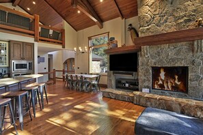 Living Room Stone Fireplace with Large Smart TV.