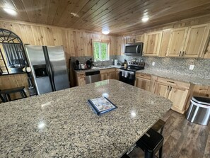 Fully stocked kitchen with Huge Island Great seating for 8