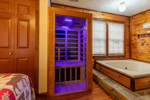 Infrared wooden sauna with multicolored therapy light.