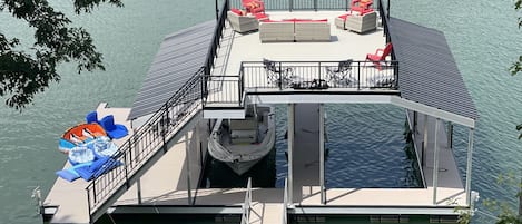 Super-sized dock on deep water with party deck, two boat slips and water toys.