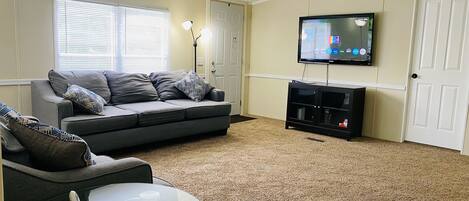 Main Living room with 2 couches, smart tv and cable.