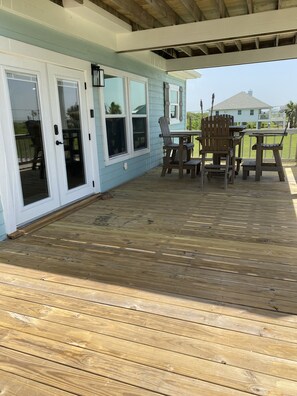 Front porch with bar height table and four captain chairs. Enjoy the ocean view