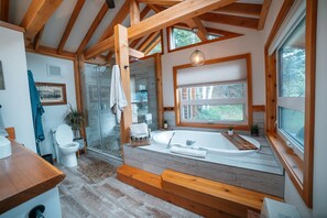 Spa-style bathroom with large soaker tub, mountain views, and large shower