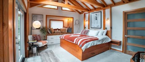 Master bed room features a custom king bed, skylights and large wood beams