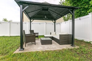 Enjoy the large private backyard from under the furnished gazebo.