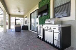 Covered patio with summer kitchen and smart TV