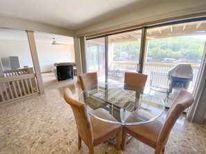 Dining room with lake view and patio access.