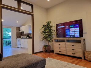 Cozy living room with 65” smart Roku TV to watch all your favorite shows