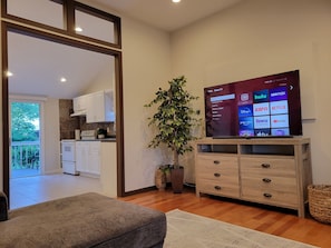 Cozy living room with 65” smart Roku TV to watch all your favorite shows