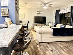 Open floor plan with breakfast bar & 3 stools on each side