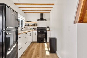 Fully-stocked kitchen with high-quality cookware, dining ware and utensils.