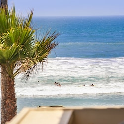 Watch swimmers and boogie boarders in the waves from your balcony!