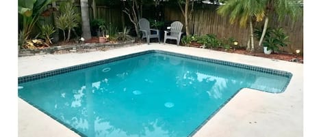 Private pool surrounded by tropical landscaping 