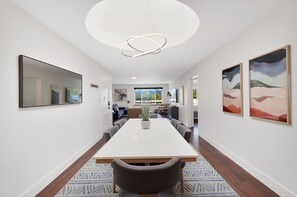 Custom built white oak dining table with quartz top seats 6