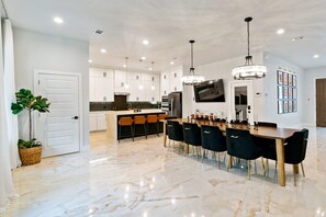 Beautiful 10ft dining table with velvet wingback dining chairs.