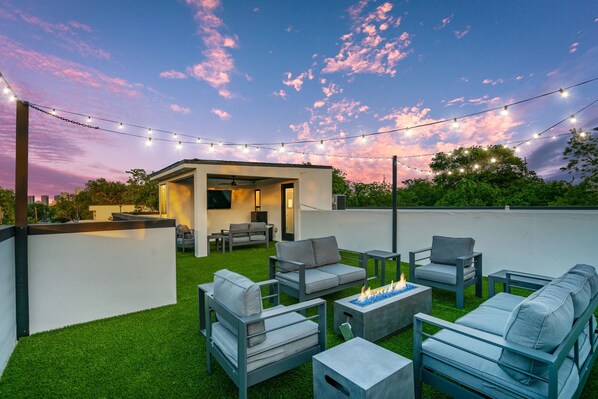 Rooftop patio with comfy outdoor furniture, gas fire pit, outdoor 55" TV + more!