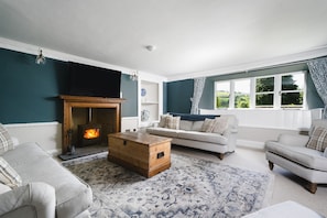 The living room with log burner at Holwell Farmhouse, Devon