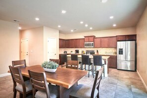 Dining area and our fully equipped kitchen with counter-top and chairs.