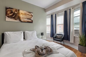 Spacious bedroom with a Queen-sized bed and contemporary design, offering ultimate comfort