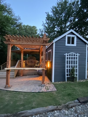 An idyllic escape: The side view reveals the enchanting outdoor space and deck of this adorable tiny home, perfect for taking in the beauty of nature.