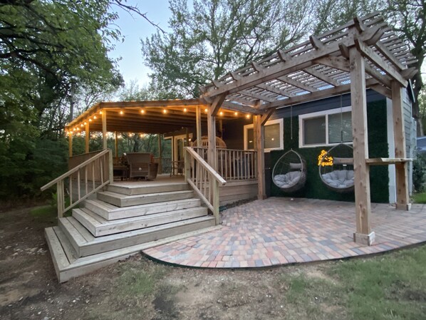 Small in size, big on charm! This tiny home's spacious deck and clever outdoor setup make the most of every inch of space for relaxation