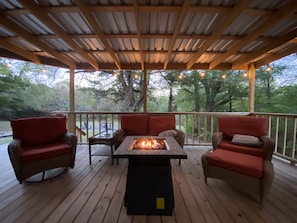 An intimate fireside retreat on the back deck of this adorable tiny home—a cozy corner for shared moments and warmth