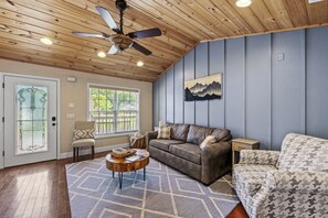 Light filled living room with sleeper sofa.