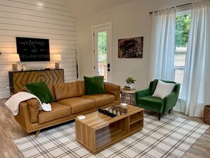 Comfortable Leather Couch and Cozy Velvet Chair to relax in front of a fire or snuggle up for a movie.
