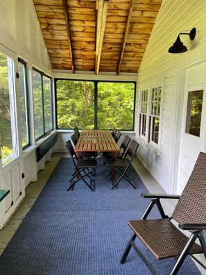 Front screened in porch with dining table