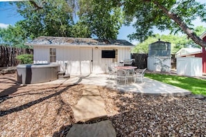 Courtyard with hot tub, tv, grill and seating