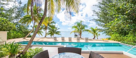 Alfresco dining table along the pool deck.