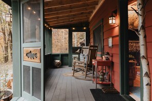 Screened in porch with rocking chairs